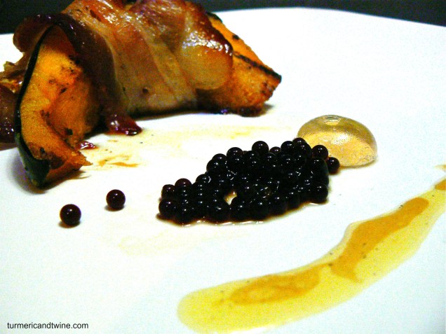 Bacon wrapped acorn squash with balsamic caviar and maple sphere