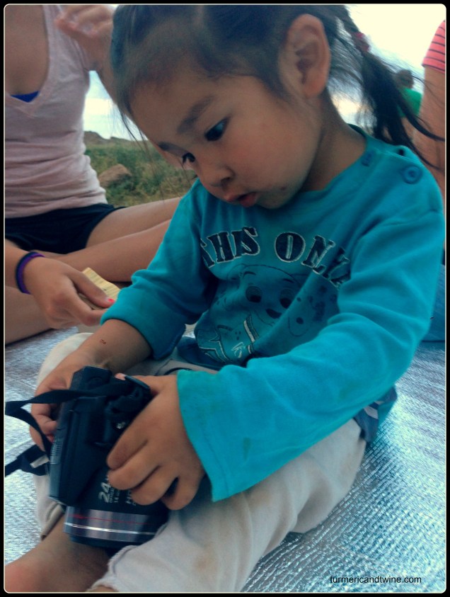 Mongolian boy playing with camera